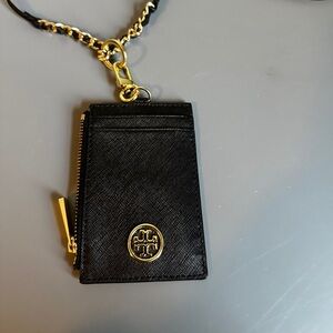 Gently used black Tory Burch Robinson lanyard - holds 4 cards with zip pouch